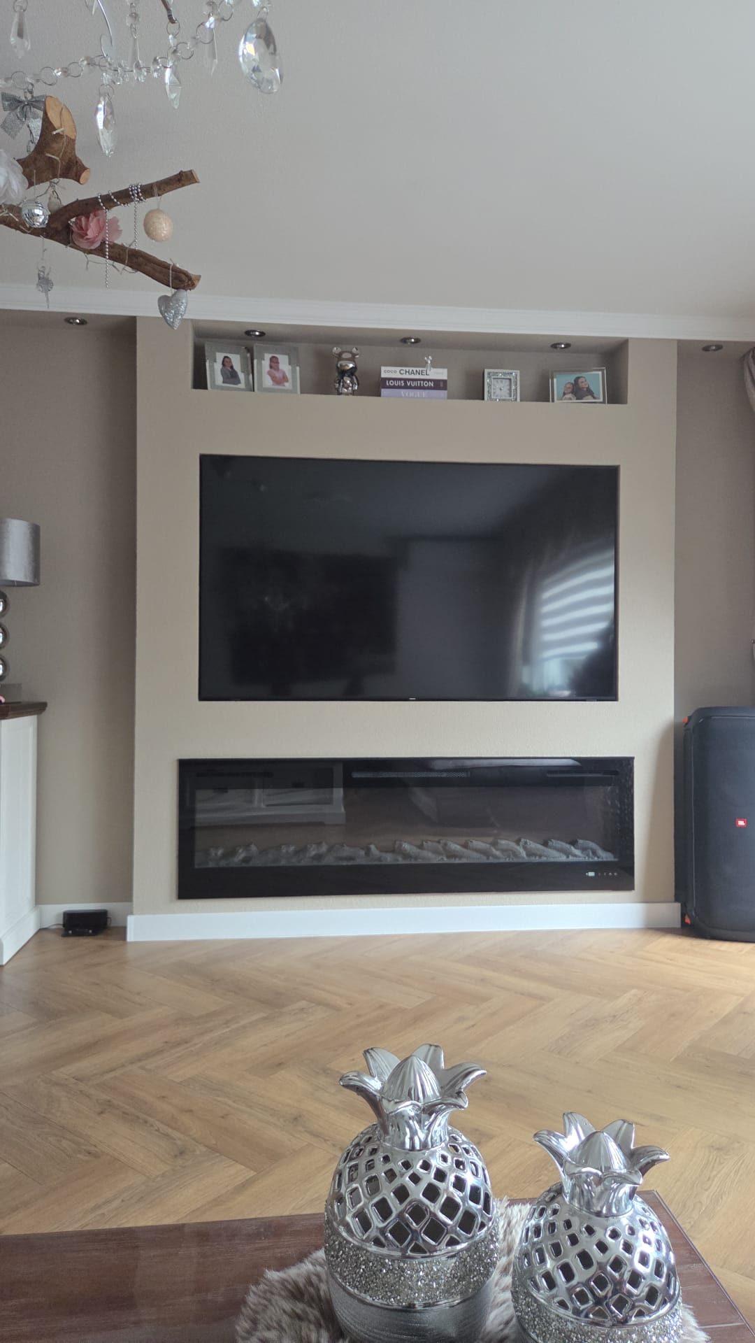 Ingebouwde tv-wand met sfeerhaard en nis in een woonkamer.